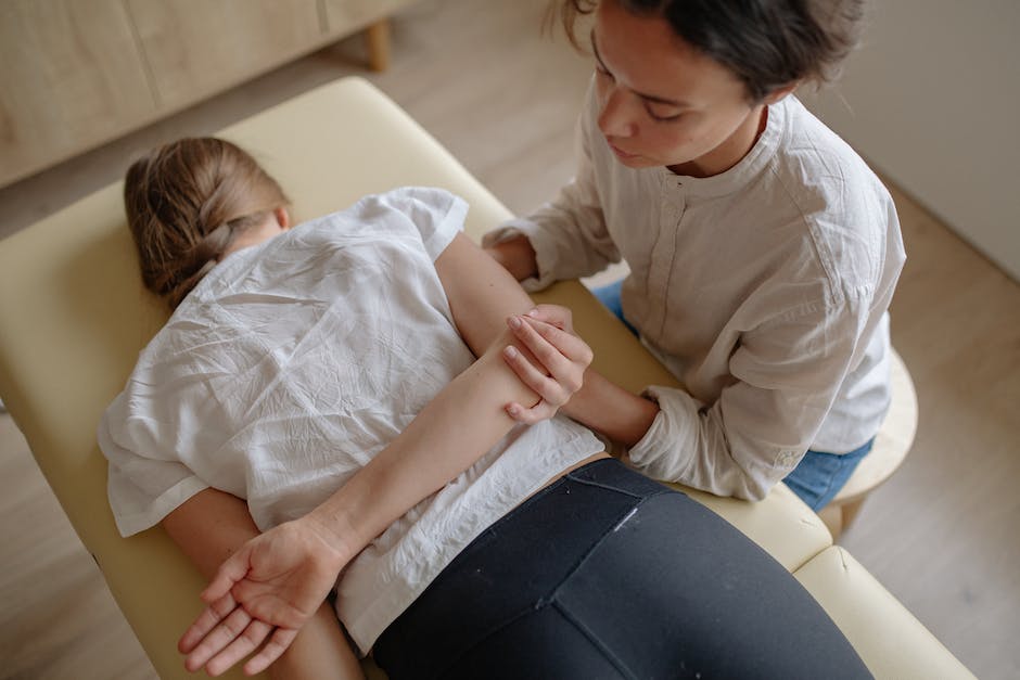Image of a chiropractor performing a spinal adjustment with the patient lying on a chiropractic table, demonstrating the process of shifting misaligned vertebrae back into position.