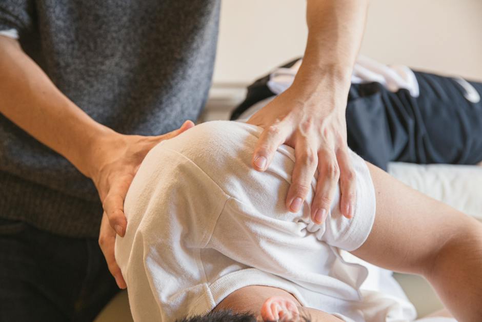 Image of a person receiving chiropractic treatment, with a practitioner adjusting their spine