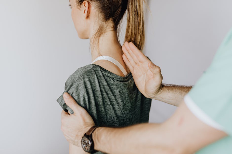 Image Description: A person receiving a spine adjustment, with a chiropractor applying pressure to their spine.